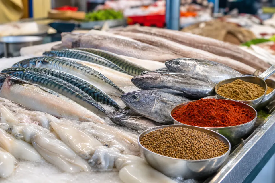 Fresh mackerel, cuttlefish, little tunny, and spices at a Ceuta-style market counter